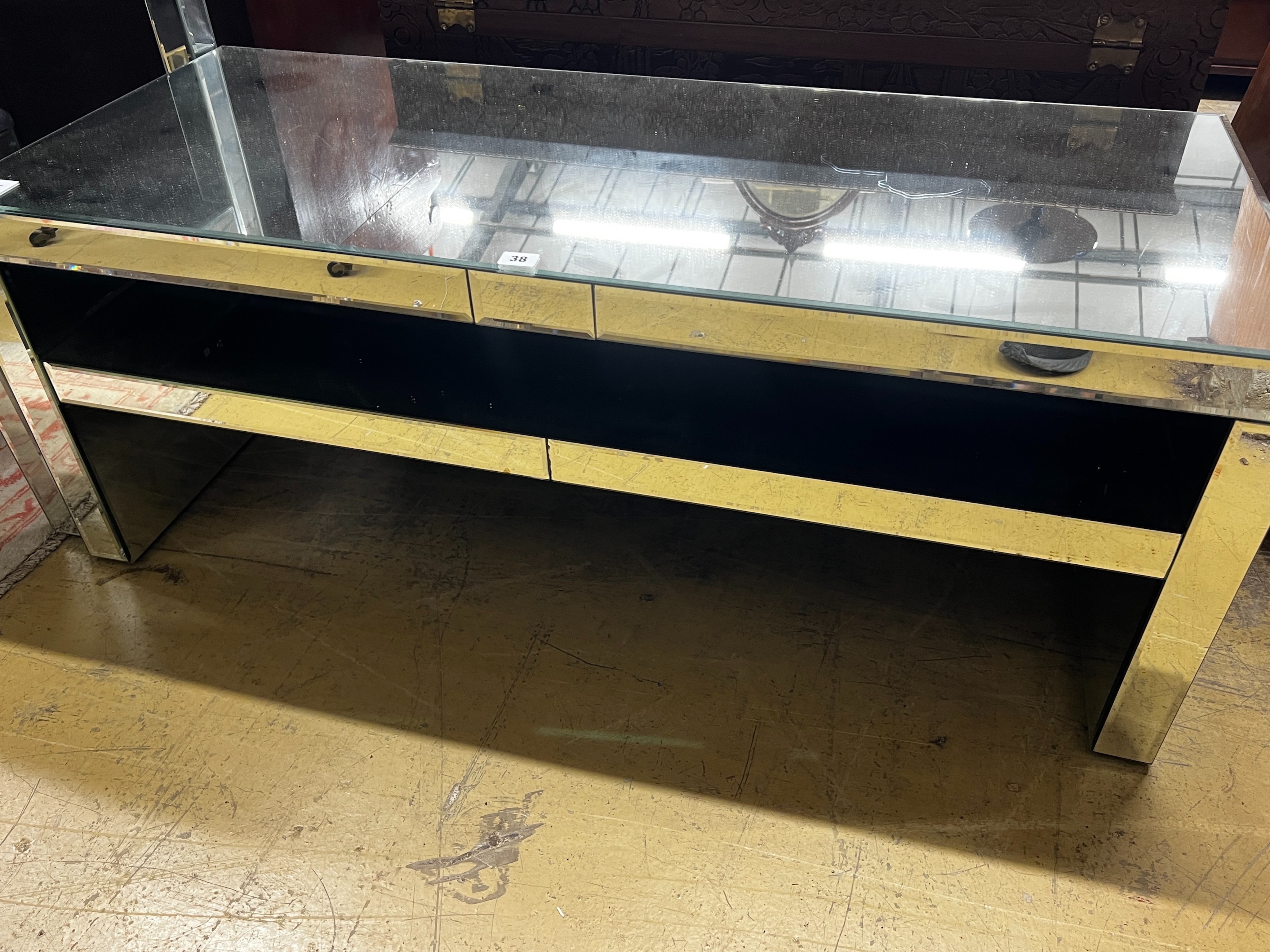 A contemporary mirrored coffee table, width 120cm, depth 50cm, height 46cm